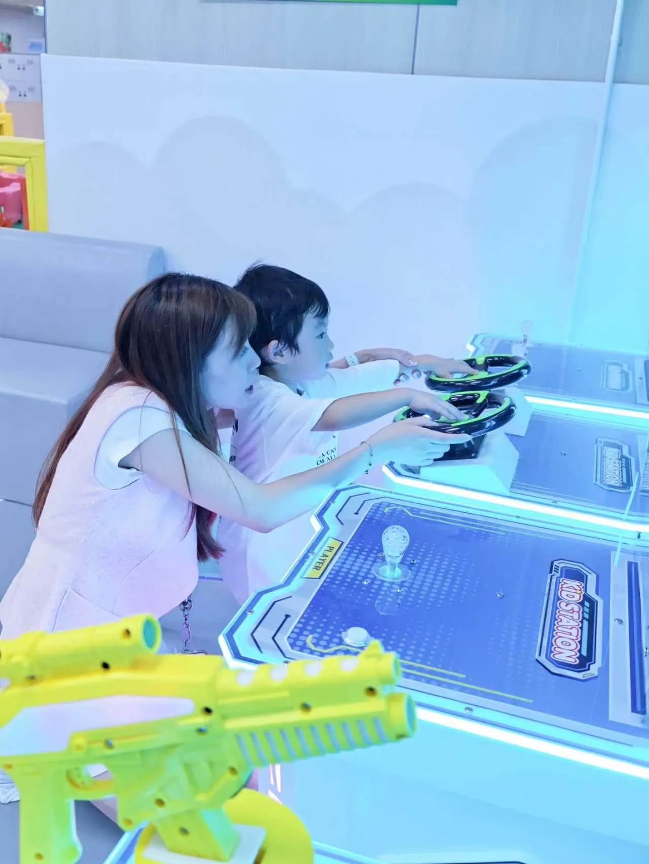 Playing an arcade game at Kidstation North Point